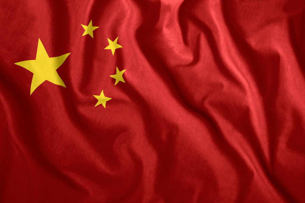 the chinese flag is flying in the wind. colorful national flag of china. patriotism, patriotic symbol.