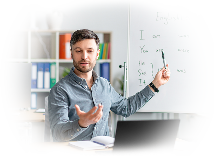male english teacher giving remote lesson via laptop communicating with students webcam office1